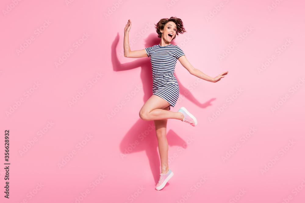 Full length profile photo of attractive lady skinny shapes good mood jumping high up rejoicing wear casual white blue summer dress shoes isolated pastel pink color background