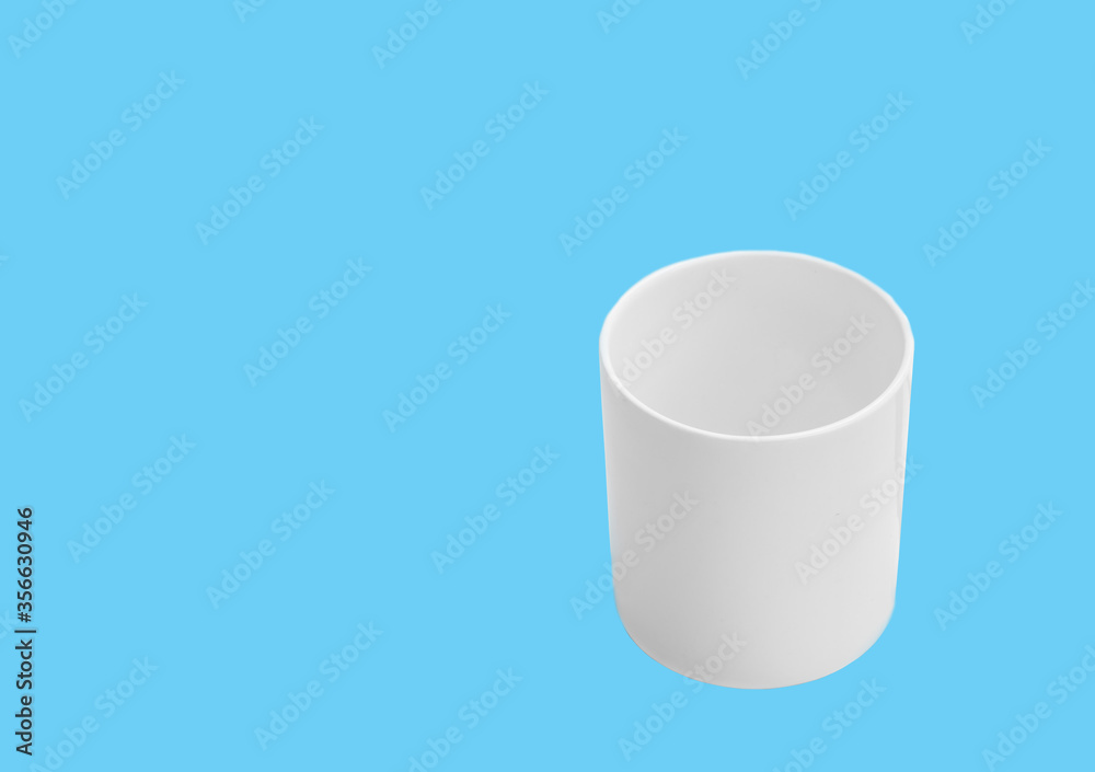 Mock up white ceramic cup on blue background Mock up white ceramic cup on blue background