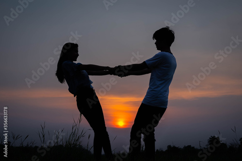silhouette romantic couple lover enjoying on sunset.