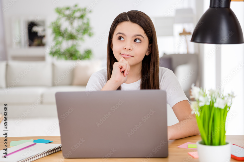 Photo of little school girl notebook online lesson video conference listen teacher minded think over interesting question sitting table desk distance quarantine study comfort room indoors Photo of little school girl notebook online lesson video conference listen teacher minded think over interesting question sitting table desk distance quarantine study comfort room indoors