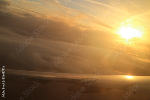 Dazzling sun on the cloudscape as seen from the plane window © jobi_pro