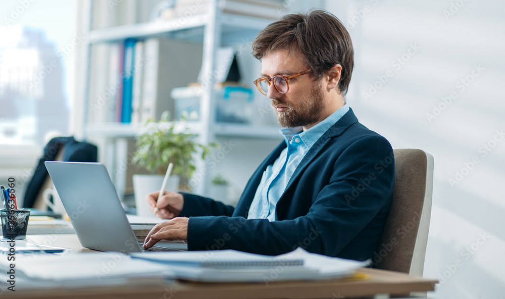 Young businessman working on a laptop Young businessman working on a laptop