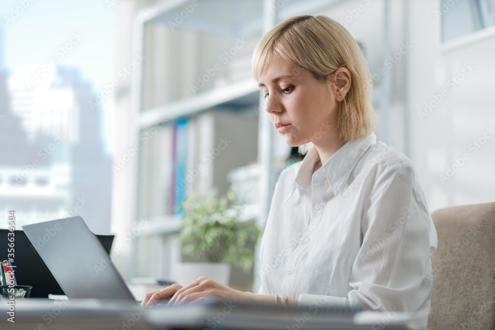 Woman in office working on a computer Woman in office working on a computer