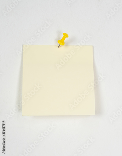 yellow sticker on a white wall