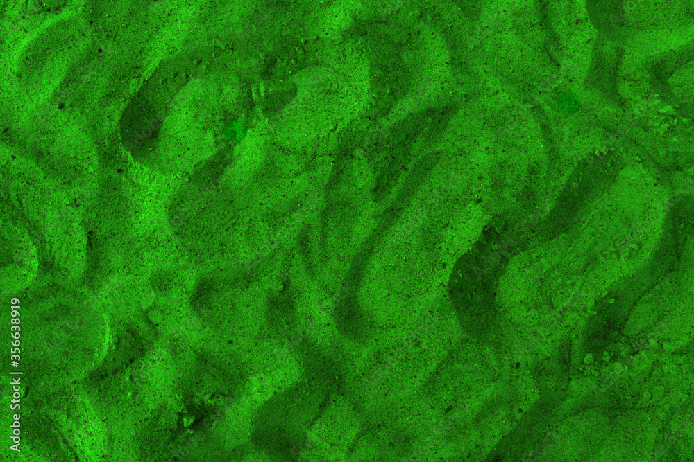 Closeup image of beautiful green sand grains with patterns for background. Green background with space for text