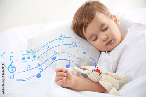 Fényképezés Flying music notes and cute little baby sleeping with toy at home