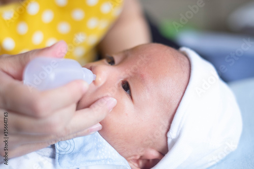 mother nasal washing cleaning baby nose by salt water
