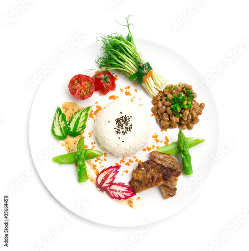 Natto with rice and grill pork Japan fusion style food healthy mini side dish decorate pea sprouts roll salad sasemi sauce  asparagus ,pickled cucumber and radish top view isolated on white background