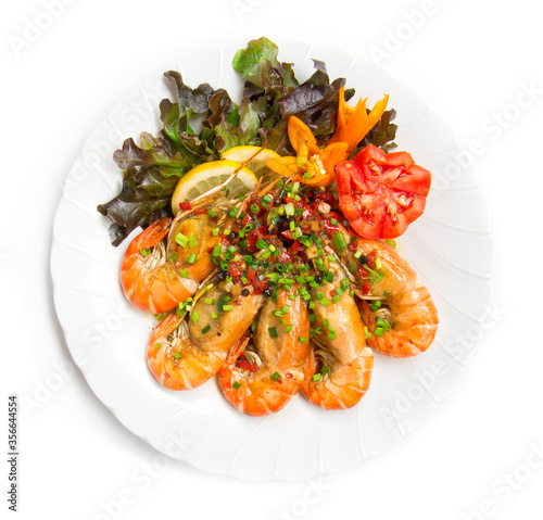 Shrimp Stir fried with chili slice and salt Thai food fusion decorate with carved tomato and yellow chili vegetables, leaf red oak top view isolated on white background