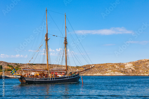 Old sailing ship on a rocky coastline