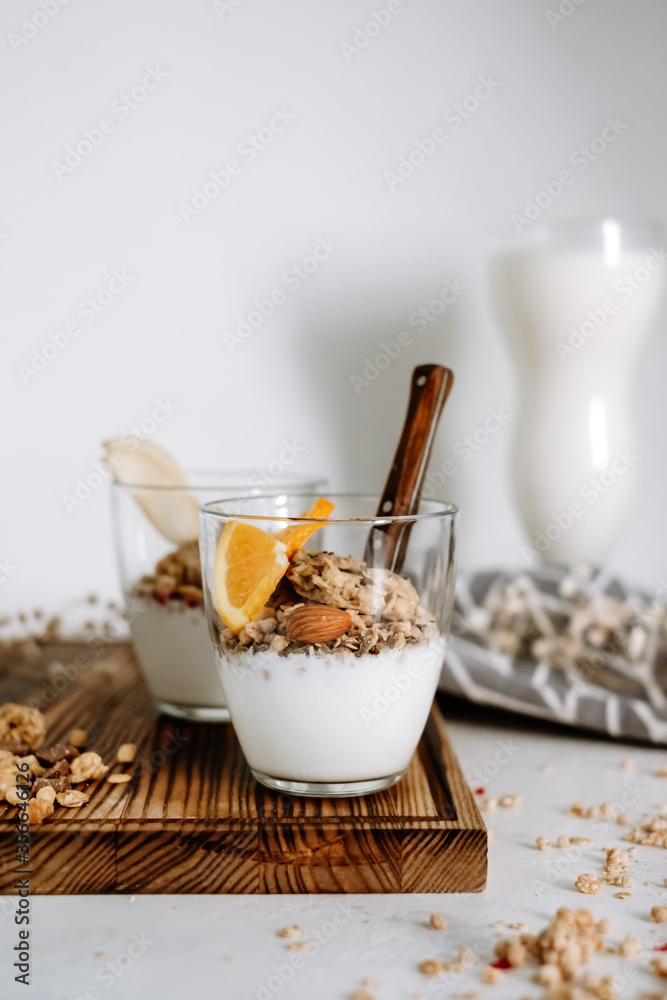 Granola and natural yogurt with slices of fruits and nuts in a glass cup, healthy breakfast. Granola and natural yogurt with slices of fruits and nuts in a glass cup, healthy breakfast.