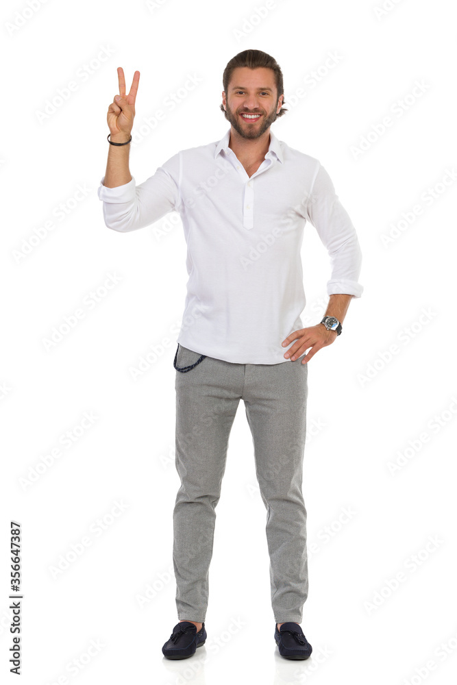 Handsome Elegant Man Is Standing And Showing Peace Hand Sign. Handsome Elegant Man Is Standing And Showing Peace Hand Sign.