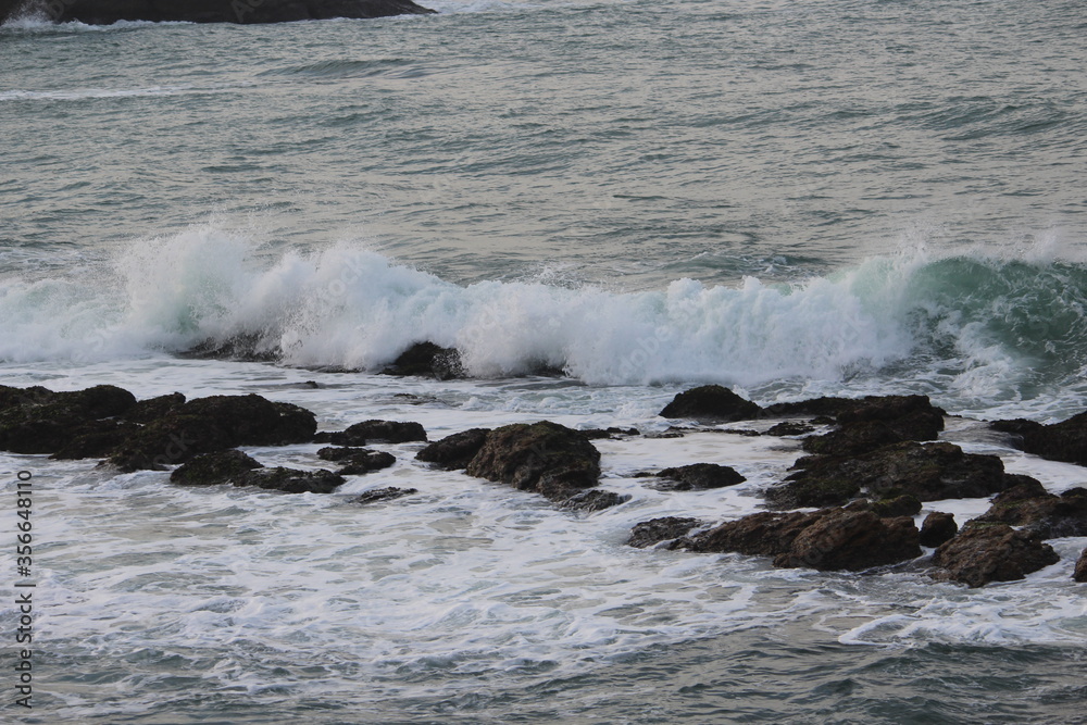 A Beautiful Milky sea waves are trying to hit the Brownie Rocks at Indian Ocean of KanyaKumari A Beautiful Milky sea waves are trying to hit the Brownie Rocks at Indian Ocean of KanyaKumari