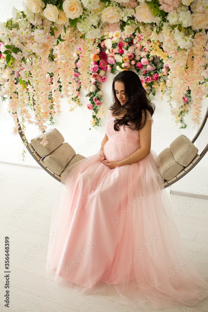 Fototapeta premium Pregnant woman at pink dress