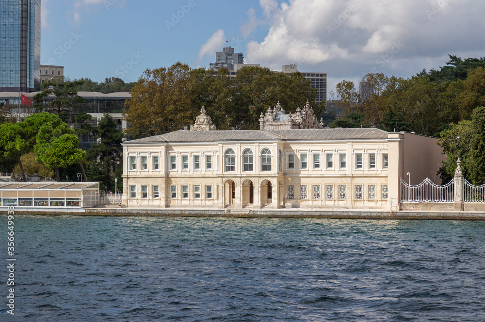 View of the architecture of Istanbul from sea. Building from complex of Dolmabahce Palace. Besiktas district on the European coast of the Bosphorus Strait. Background for travel postcard