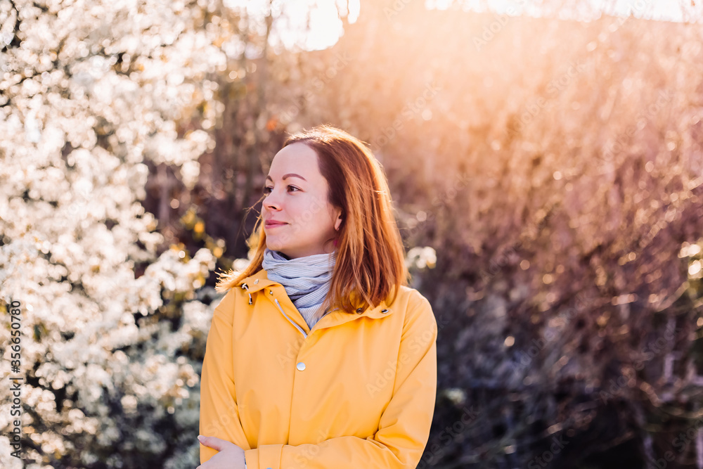 Smiling woman in blooming cherry garden Smiling woman in blooming cherry garden