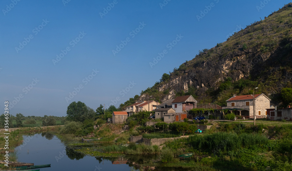 A small village on a hill near a lake in Montenegro