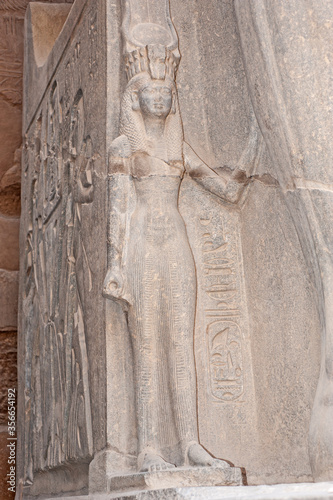 Statue and hieroglyphic carvings at an ancient egyptian temple