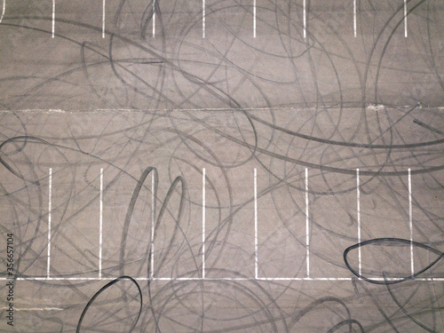 Aerial top down drone shot. Parking with tire tracks. Drifting location.