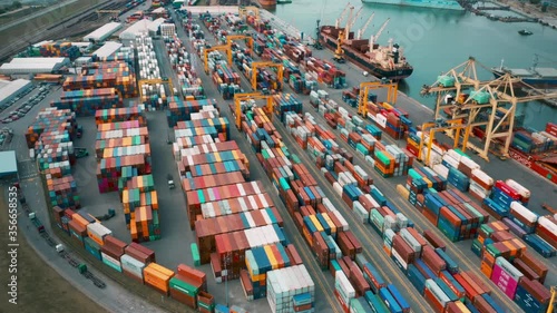 Cargo containers in busy port, aerial hyperlapse. Shipping harbor, logistics photo