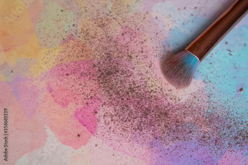 Make up brush with powder on colorful background. Copy space