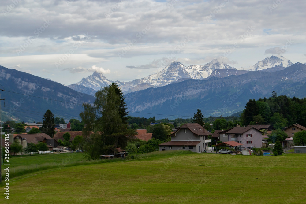 view of alpine mountains and village in Switzerland
