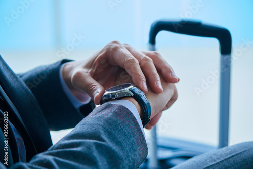 businessman watching his watch at the airport