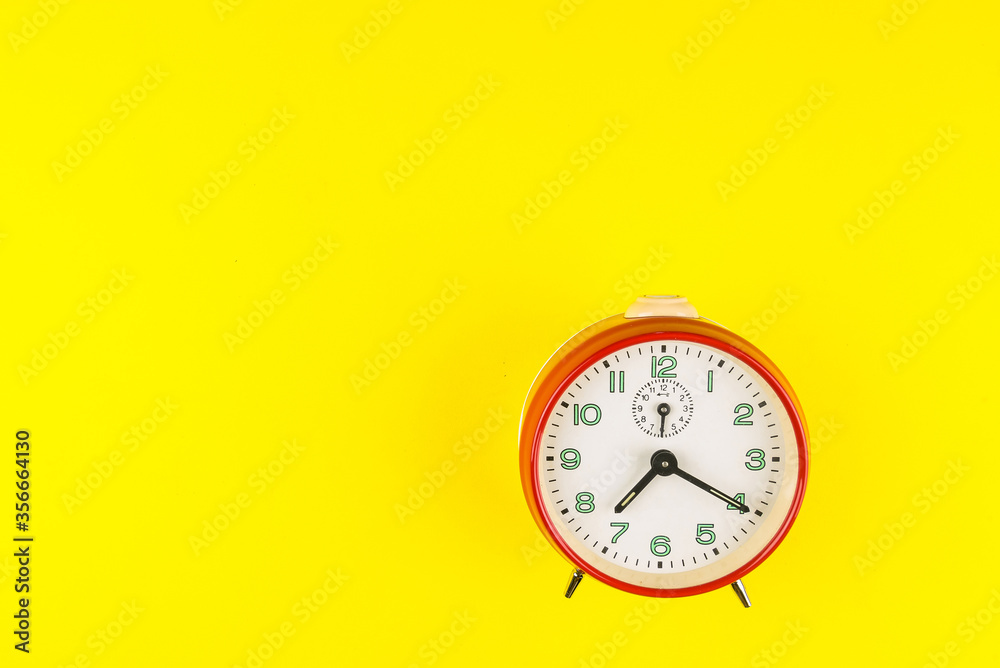 Red alarm clock isolated on yellow background, Time concept, Rush hour concept, Copy space image for your text, Flat lay Red alarm clock isolated on yellow background, Time concept, Rush hour concept, Copy space image for your text, Flat lay