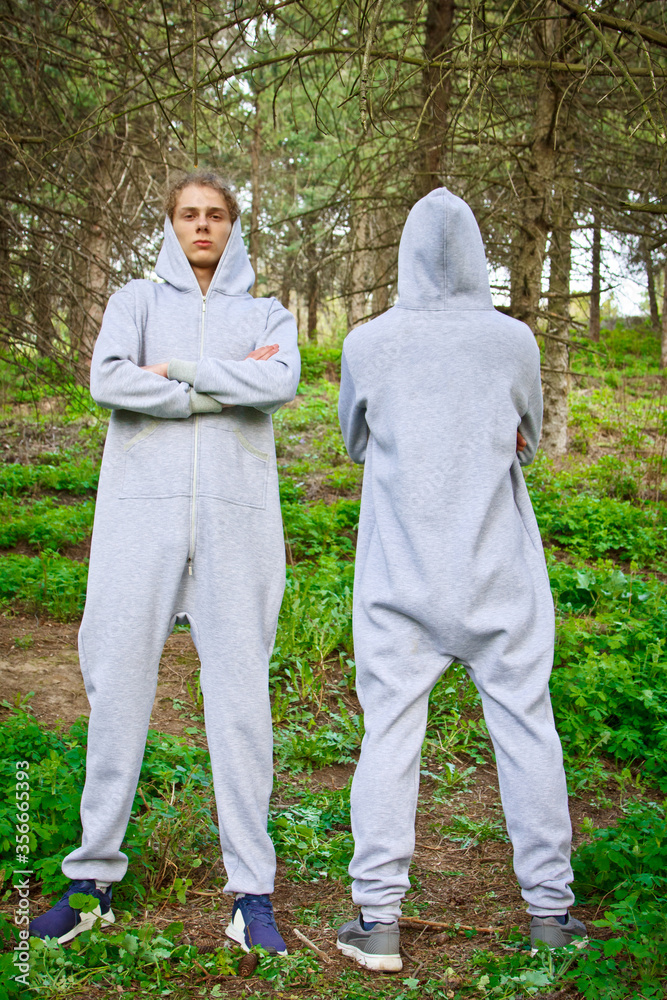 Beautiful, young guys in tracksuits play sports in the park outdoors. Healthy lifestyle. Beautiful, young guys in tracksuits play sports in the park outdoors. Healthy lifestyle.