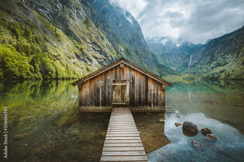 Obraz na płótnie Wooden boat house at the shores of an alpine lake in the mountains w salonie
