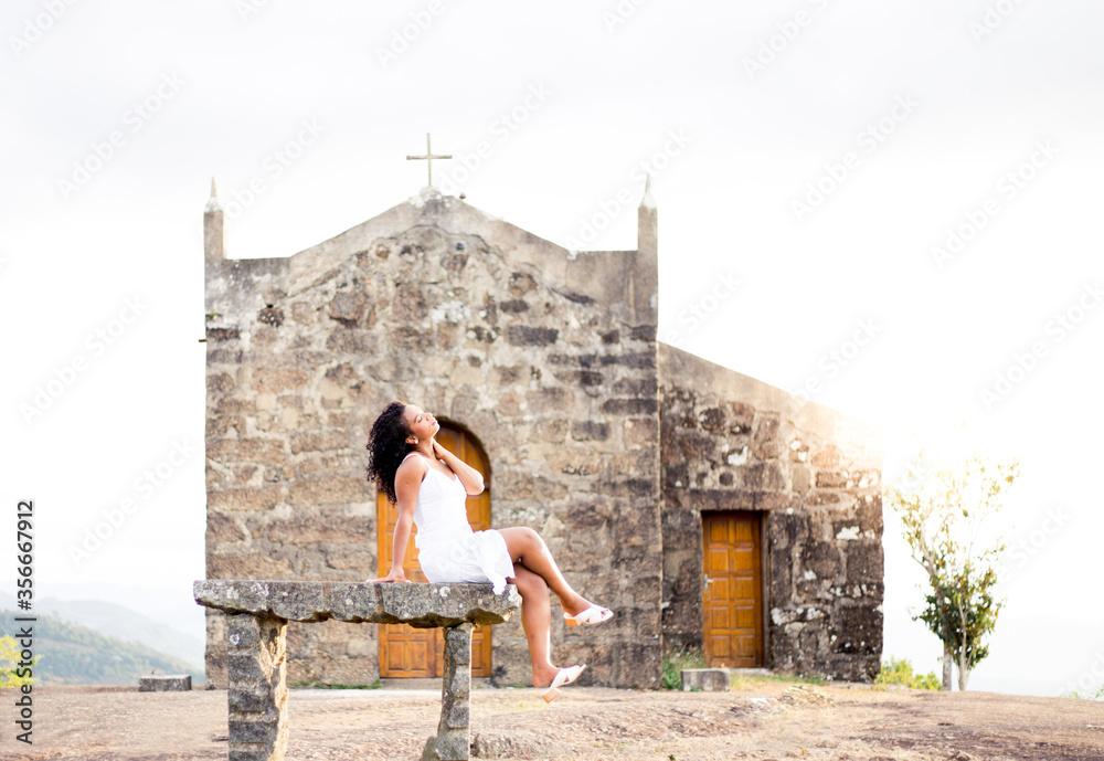 Feeling relaxed. Beautiful black woman sitting in an old church
