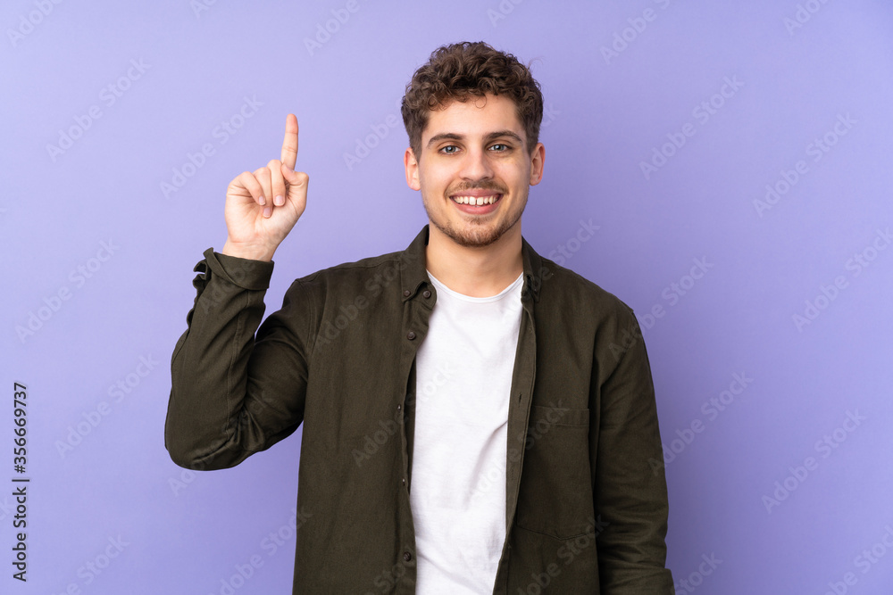 Caucasian man isolated on purple background pointing up a great idea Caucasian man isolated on purple background pointing up a great idea