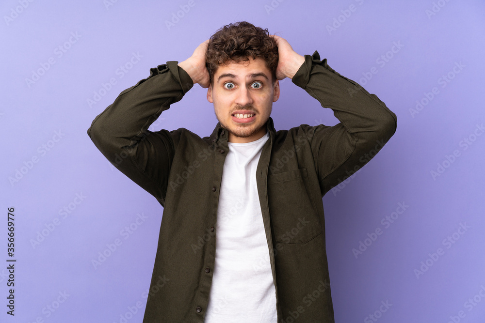 Caucasian man isolated on purple background doing nervous gesture Caucasian man isolated on purple background doing nervous gesture