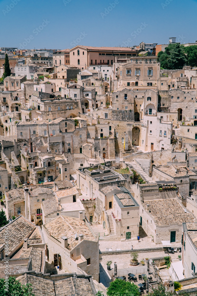 View of the dense buildings of stone houses in the medieval city of Matera, Italy. Sunny day.