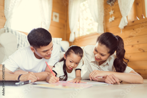 Father and mother Teaching children to do their homework at home