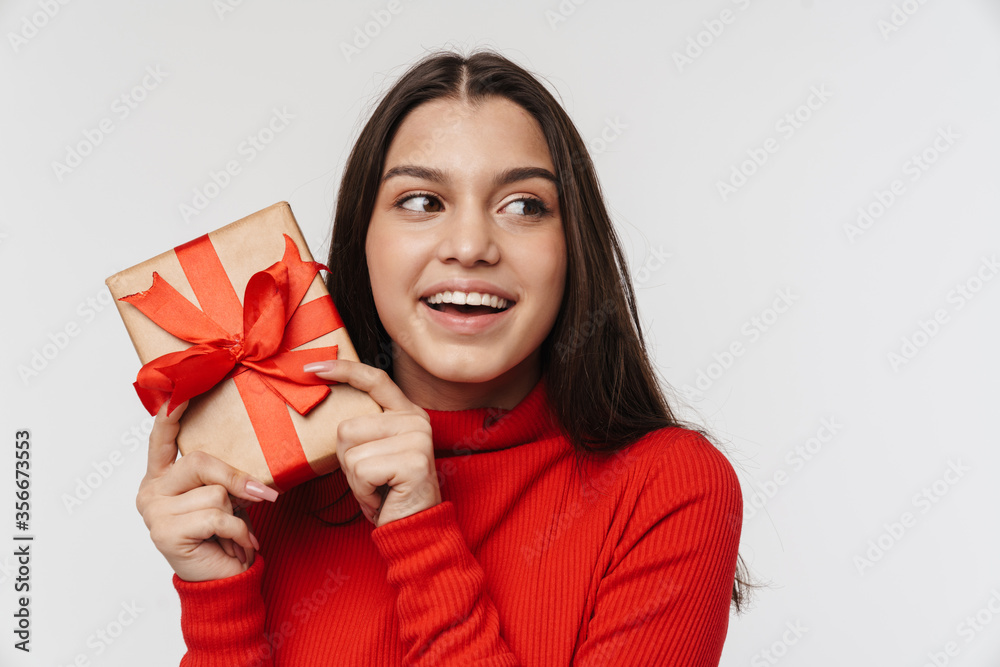 Photo of happy caucasian cute woman holding gift box and laughing Photo of happy caucasian cute woman holding gift box and laughing