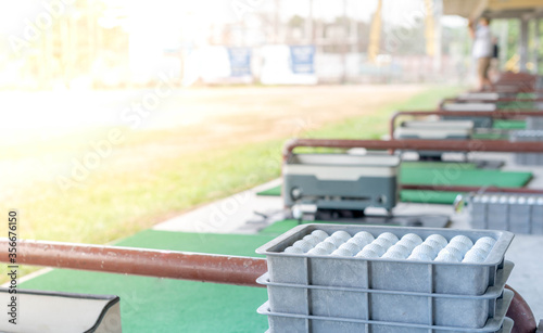 The white golf ball put on the tray preparing to the golf player to hitting at the drive range golf and for the practise to up skill to professional golf.