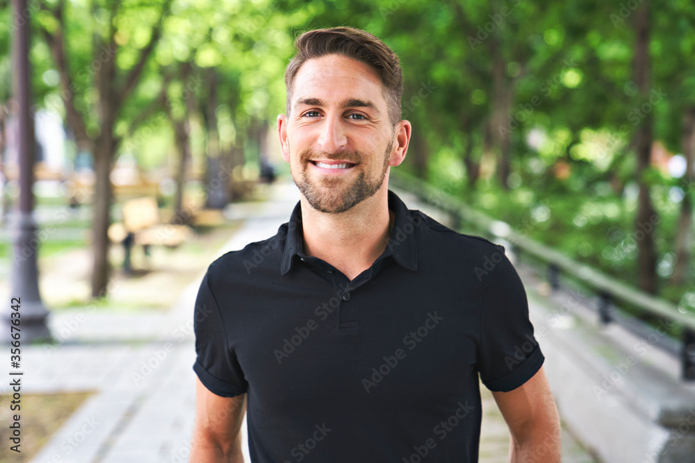 Portrait of a trendy young man on a sunny day in the city