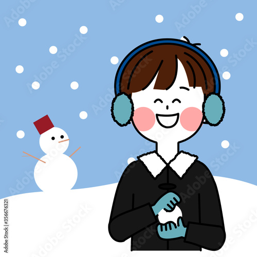 雪だるまの背景と雪で遊ぶ子供