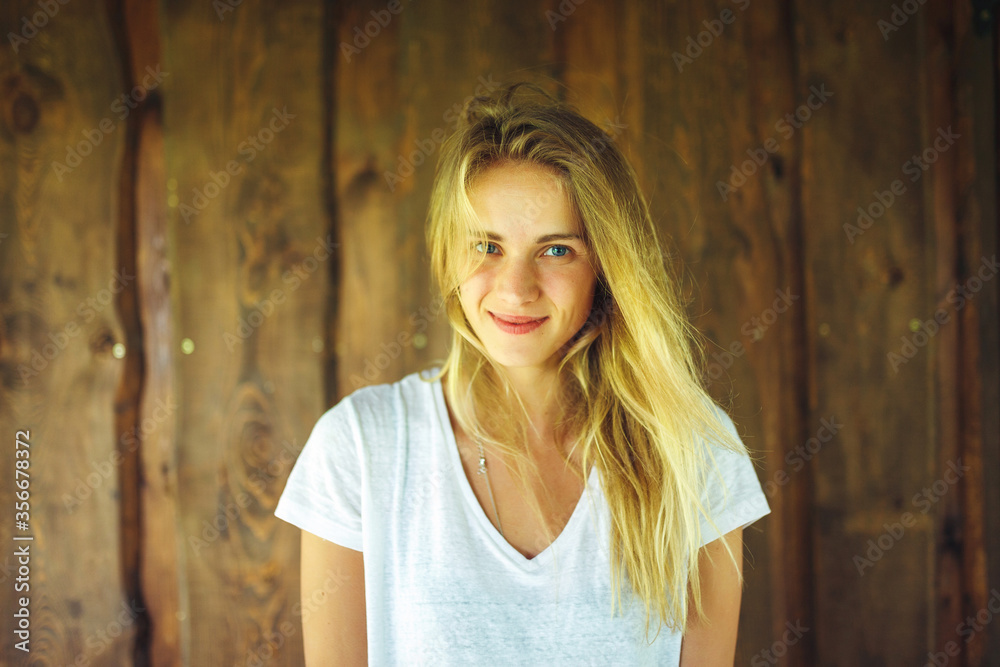 Young woman in front of wooden wall Young woman in front of wooden wall