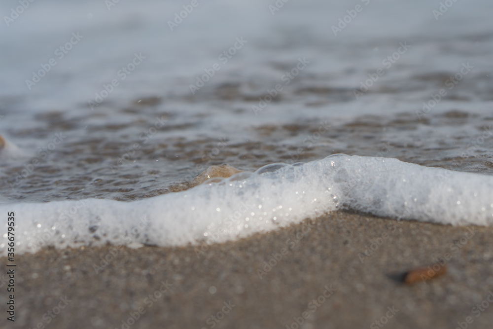 Wet sea sand washed by the waves of sea water Wet sea sand washed by the waves of sea water