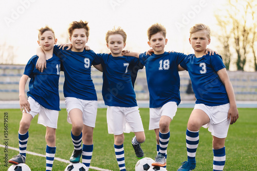 Young Boys in Soccer Team. Happy Junior Sports Group of Kids. Kids' Athletics on Football Field. Happy Children Looking at Camera