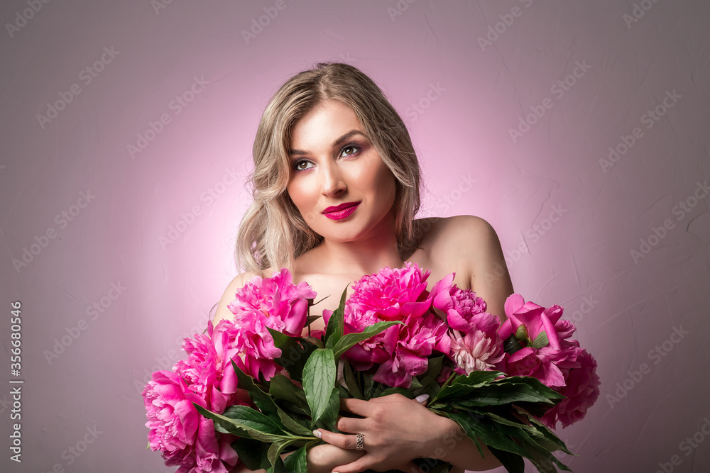 Young beautiful woman with a bouquet of peonies Young beautiful woman with a bouquet of peonies