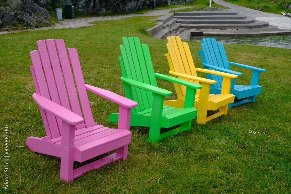 Multi coloured chairs on grass Multi coloured chairs on grass