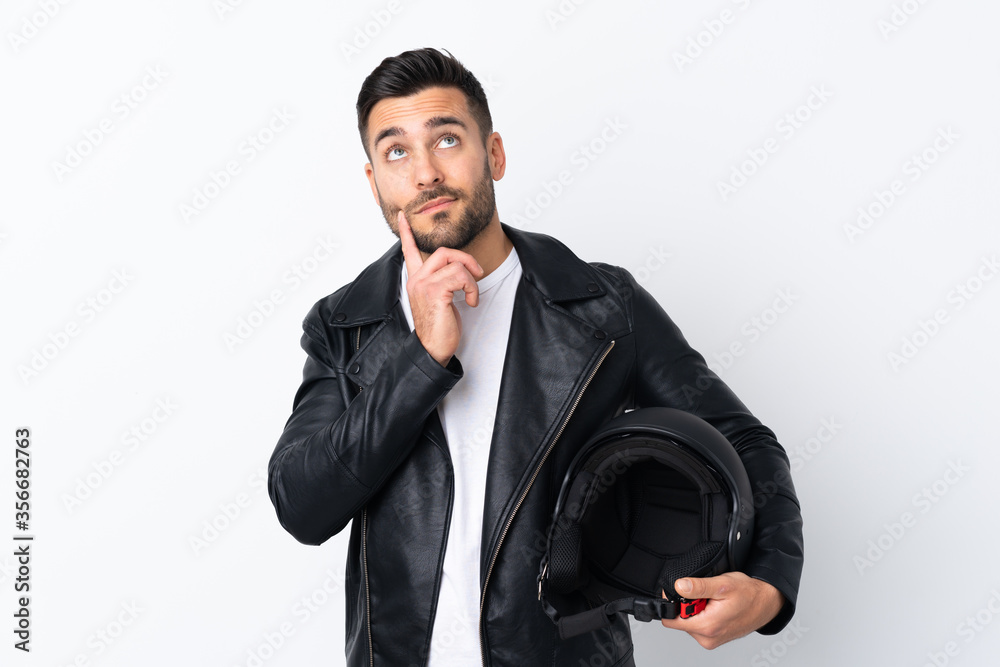 Man with a motorcycle helmet thinking an idea Man with a motorcycle helmet thinking an idea