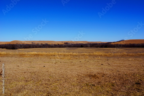 Open prairie view with dry grass in the Flint Hills of Kansas on a sunny winter's day