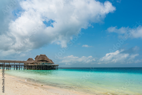 Tropical White Beach with a Traditional Building over Water, Zanzibar Island