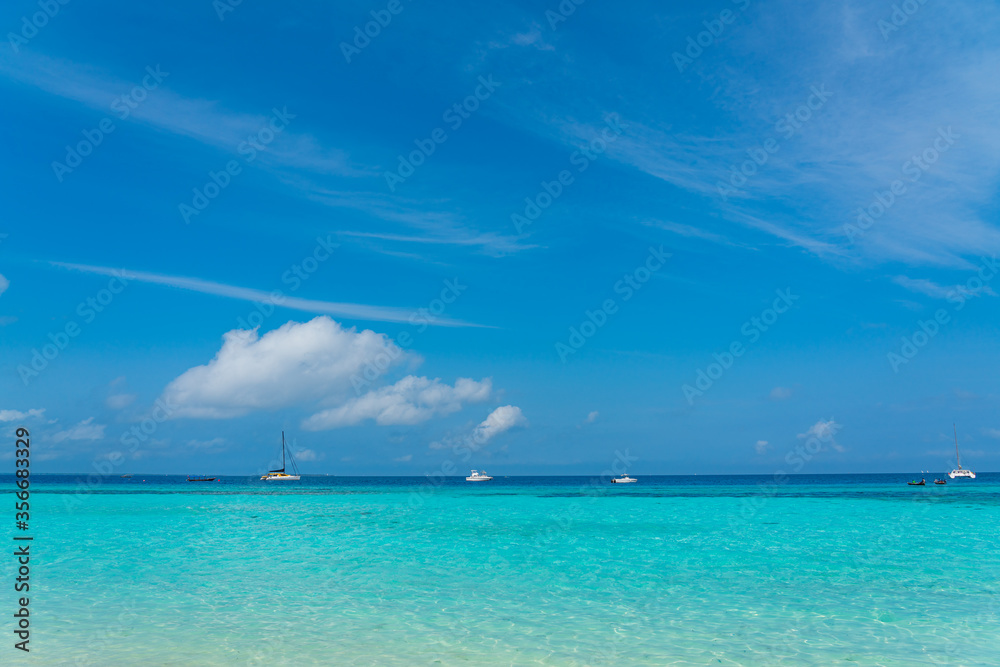 Boats on turquoise Ocean with White Sand blue Sky at Zanzibar Island, Tanzania
