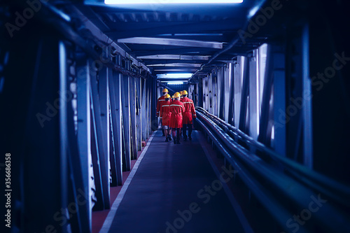 Fotografie workers  helmets at the factory, view from the back, group of workers,  change o