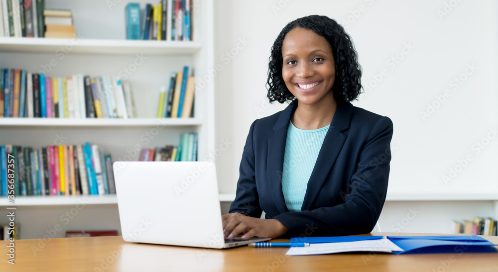 Laughing african american businesswoman working at computer Laughing african american businesswoman working at computer